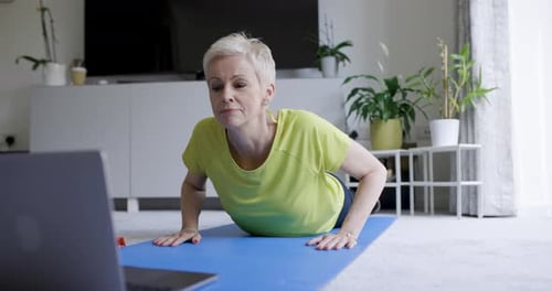 Woman Practices Yoga in Home Living Room