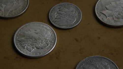 Antique Silver Coins Close Up on Brown Surface
