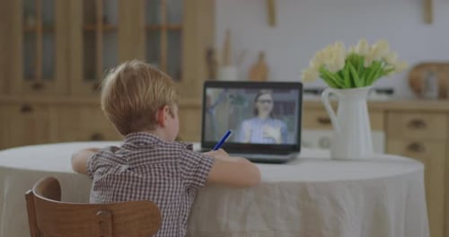 Preschool Kid Making Online School Homework with Female Teacher on Laptop Screen. Boy Studying