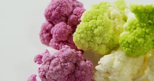 Close Up of Colorful Cauliflower Florets on White