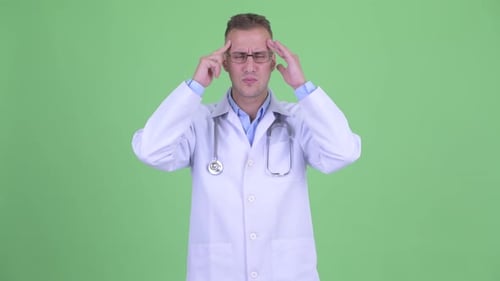 Doctor Rubbing Temples in Stress