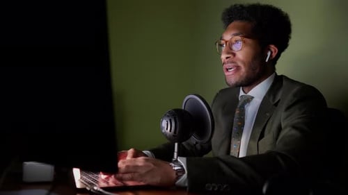 Businessman sitting in office having a conference call