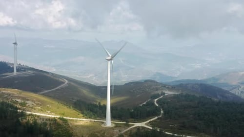 Windmill Rotating By Wind in Mountain Landscape