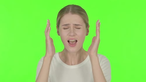 Young Woman Shouting and Screaming on Green Background