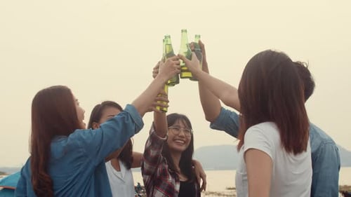 Friends Celebrating Outdoors with Bottles of Beer