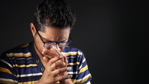 Man Clasping Hands in Thoughtful Portrait