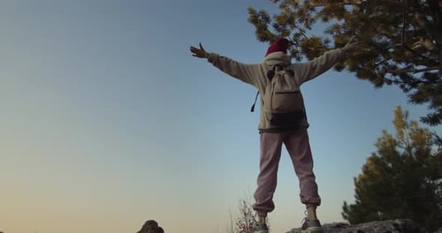 Raising Arms On Cliff