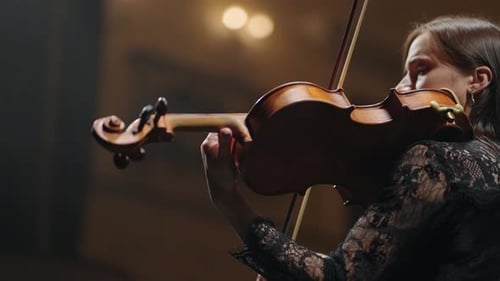 Woman Playing Violin in Music Venue