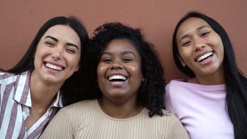 Happy multiracial friends having fun laughing together in front of video camera