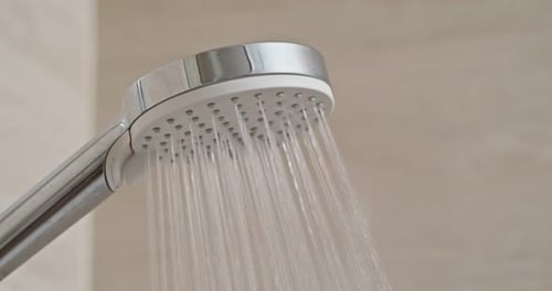 Running Water From Shower Head in Bathroom