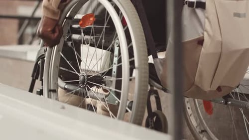 Unrecognizable Black Man Riding Wheelchair Outdoors