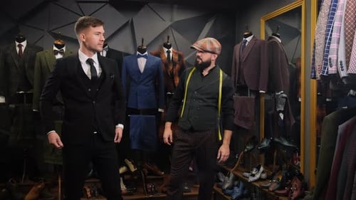 Tailor Helps the Client Choose a Classic Three-piece Suit in an Atelier, Creative Adult Stylist