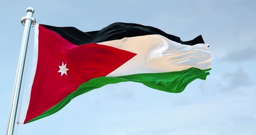 Waving Flag of Jordan Against Blue Sky
