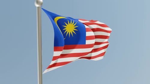 Waving Malaysian Flag on Flagpole Against Blue Sky