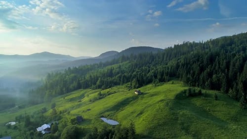 Aerial View of Rolling Green Hills and Mountains