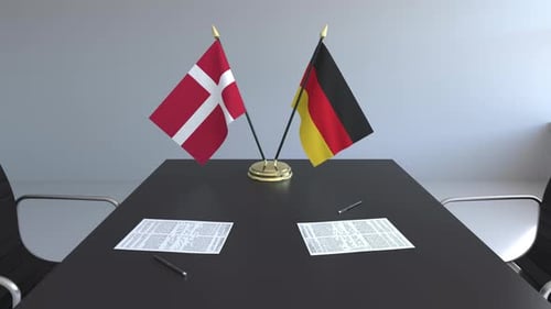 International Agreement with Danish and German Flags on Meeting Table