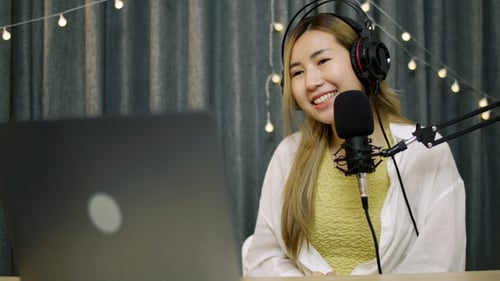 Woman Recording Podcast With Microphone and Laptop