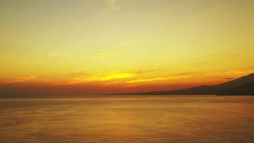 The Beautiful And Dramatic Sunrise By The Shore Overlooking At Its High Mountains And Peaceful Ocean