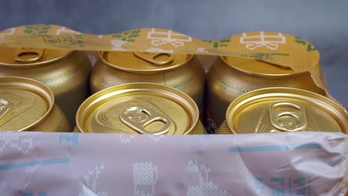Close up of Gold Cans in Decorative Packaging