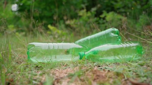 Pile of garbage on green grass in nature environment problems. Nature protection. Forests pollution