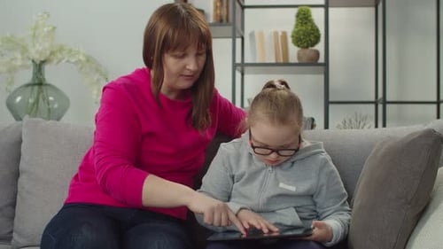 Woman and Child Using Tablet at Home