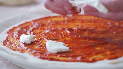 Man Puts Slices of Mozzarella on the Pizza. Man Doing Homemade Pizza
