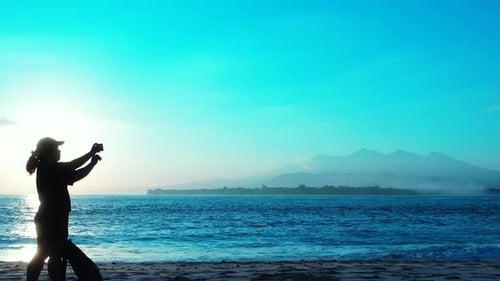 Beautiful smiling lady on holiday spending quality time at the beach on paradise white sand and blue