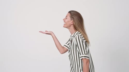 Woman Making Kissing Gesture in Studio