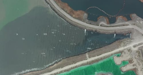 Aerial View. Drone Flying Forward Over a Polluted Sea with Destroyed Ecosystem. Slag Dump Poisoning