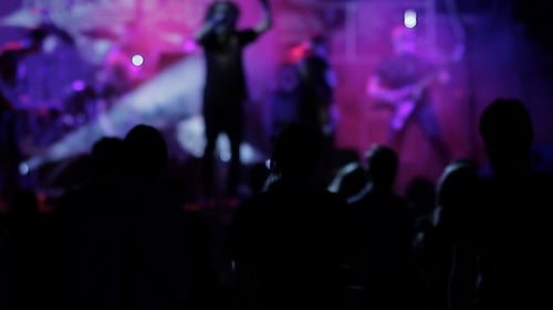 Energetic Band Performing Live Concert in Dark Venue