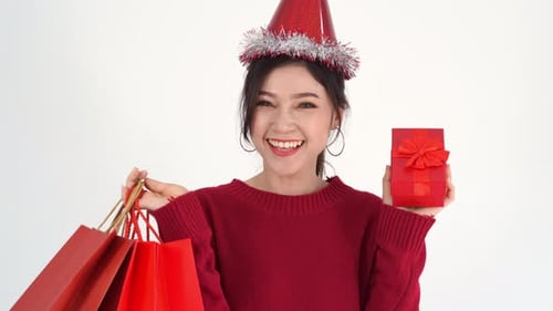 Woman Celebrating with a Gift and Shopping Bags