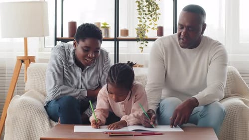 Family Coloring Together at Home During Daytime