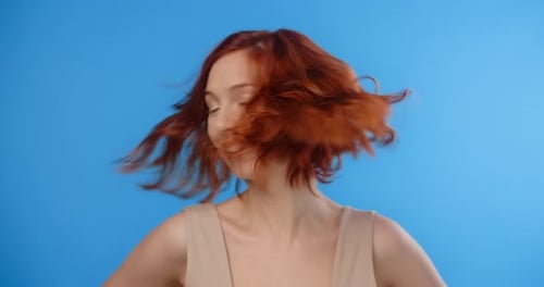 Woman Shakes Her Head Causing Her Hair to Flip