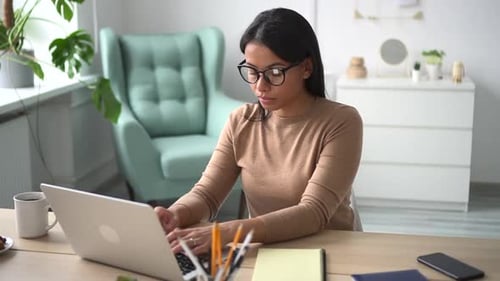 Woman Working with Laptop and Typing Sitting at Table in Home Office Spbd