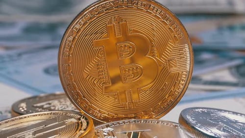 Macro View of Cryptocurrency Coins with Blurred Bills