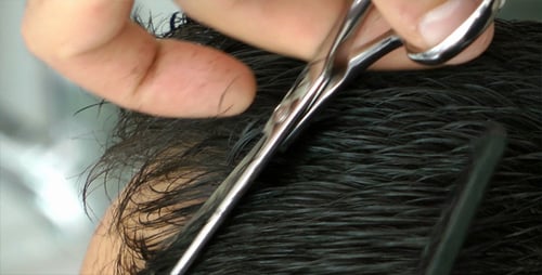 Barber Cuts Wet Hair with Scissors and Comb