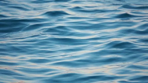 Close Up of Disturbed Blue Ocean Water Surface. Slow Motion