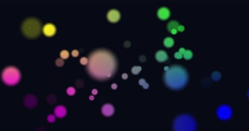 Animation von bunten leuchtenden Lichtpunkten, die sich in hypnotischer Bewegung auf schwarzem Hintergrund bewegen