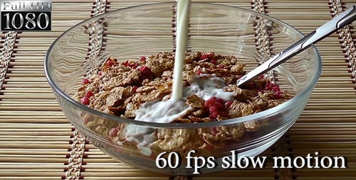 Cereal with Berries Being Poured with Milk