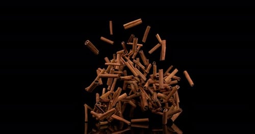 Cinnamon sticks, cinnamomum zeylanicum, spice falling against Black Background, Slow Motion 4K