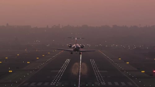 Skillful Landing at Sunset with Foggy Skies in the Background