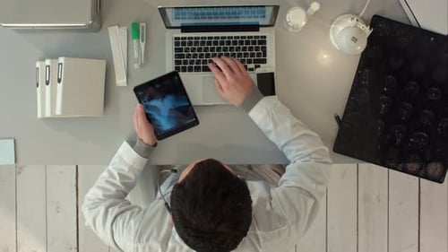 Man Using Tablet Pc Against Medical Xray