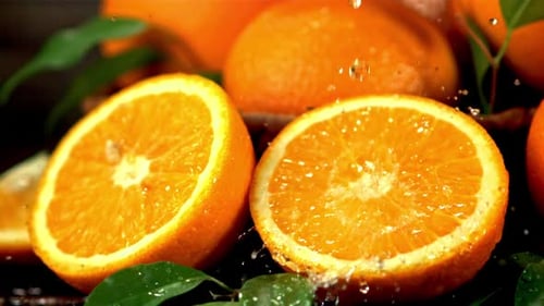 Super Slow Motion on the Halves of the Orange Droplets of Orange Juice