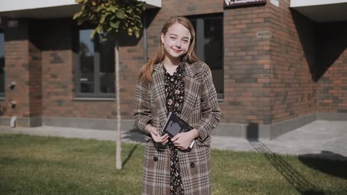 Young Woman with Book in Urban Setting