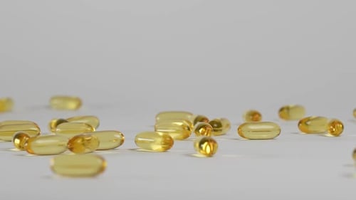 Golden Capsules Falling in Slow Motion