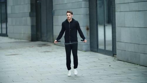 Athletic Man Exercising with Jump Rope in Urban Setting