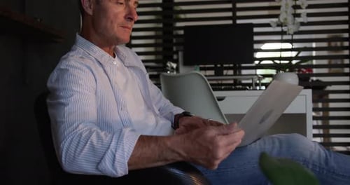 Mature Adult Working at Computer with Laptop