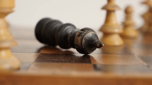 Slow motion of black player king fall on chequered fields close-up 1920X1080 HD footage - Game ends