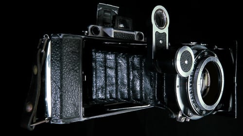Vintage Folding Camera on Black Background