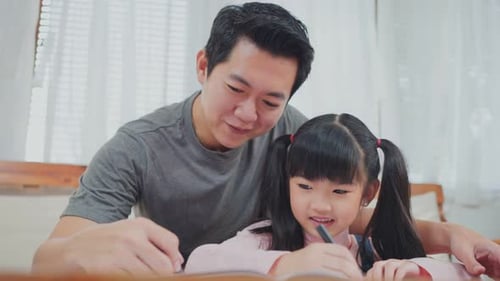 Father and Daughter Drawing Together at Home